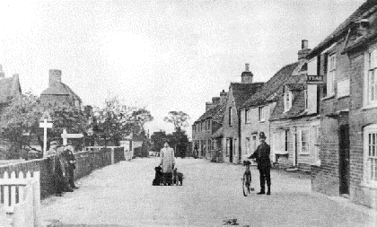 Fig. 5 Canewdon High Street in the early 20th century. The distinctive roofline of The Algiers is visible in the left background, with the gable of Canute House just visible slightly set back from this. The Anchor pub is in the right foreground. The buildings beyond this on the right have now gone, and the area is occupied by Costcutters, the school car park and late 20th century houses.