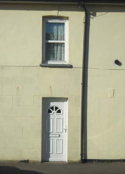 Fig. 79 Plastic replacement window and door, Prospect Cottages.