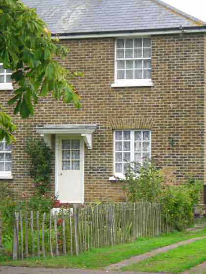 Fig. 19 Small paned casements and sash windows, traditional door with simple canopy, no.18 Churchend.